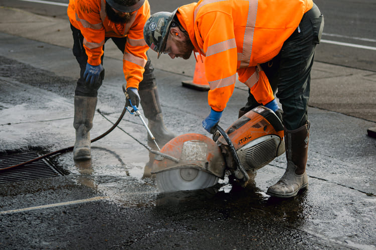 Lovett crew saw cutting around catch basin